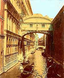 Colored old photograph of Venitian canal with gondoliers